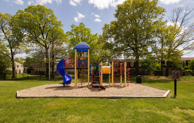 a playground with a blue slide and monkey bars