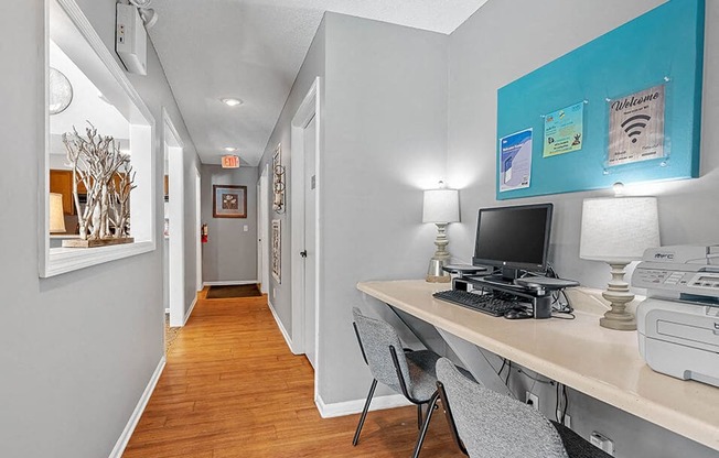 a home office with a computer desk and a printer