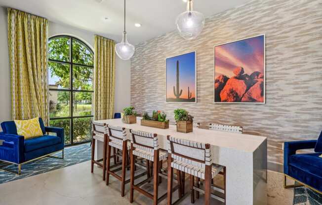 a dining room with a long table and chairs and a large window