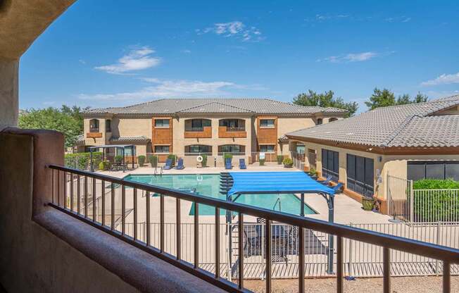 A pool in a courtyard surrounded by houses.