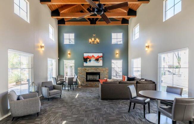 A spacious living room with a fireplace and a ceiling fan.