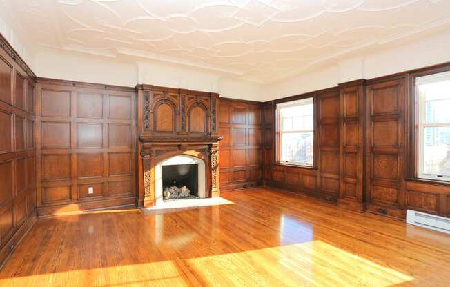 York House penthouse living room with hardwood floors, fireplace and wood panelling at York House, Saint Louis, 63108