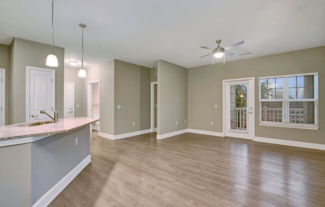 spacious living area with patio door and kitchen island at York Woods at Lake Murray Apartment Homes, Columbia, SC