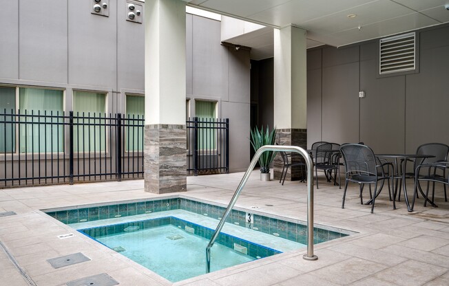 a swimming pool in a room with tables and chairs