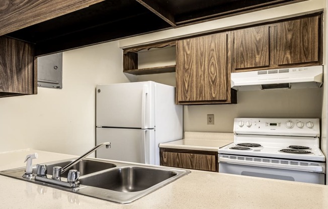 a kitchen with a sink and a stove and a refrigerator