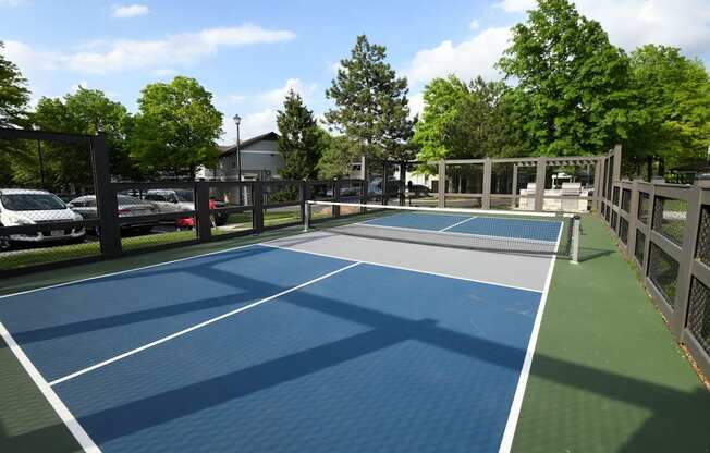 A tennis court with a blue surface and white lines.