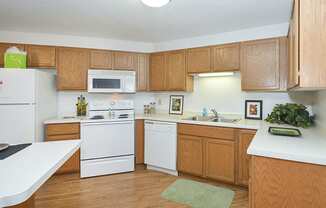 Fully-Equipped Kitchen with White Appliances and Wood Cabinets