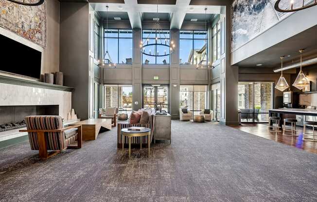 a large living room with a fireplace and large windows