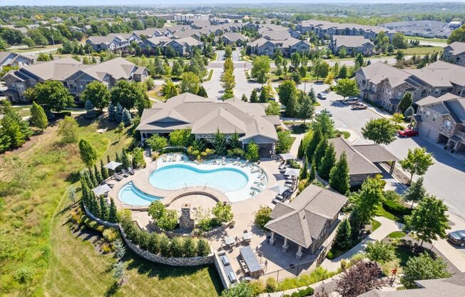 an aerial view of a house with a pool in the yard