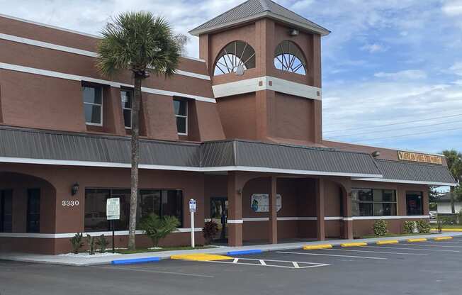 a building with a clock tower on top of it at Colonial Apartments, Orlando, 32808