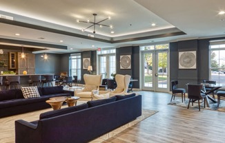 a living room with couches and chairs and a table and chairs in a lobby