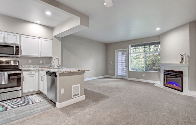 A modern kitchen with a dining area and a fireplace.
