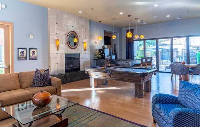 a game room with a pool table and a fireplace