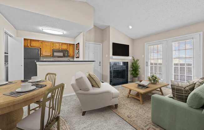 a living room with a couch a chair a table and a fireplace