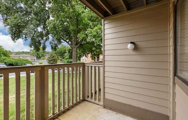 A balcony with a light on the wall.