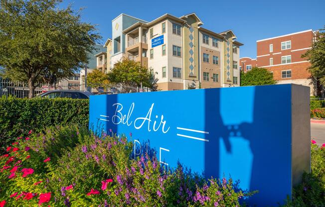 a close up of a flower garden in front of a building