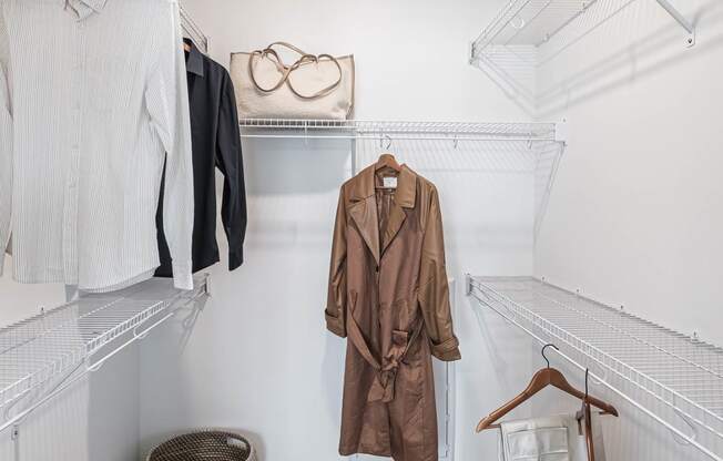 a walk in closet with coats and jackets hanging on the wall  at Altis Grand Suncoast Apartments, Florida, 34638