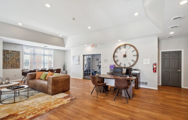 a living room with a large clock on the wall and a dining room table