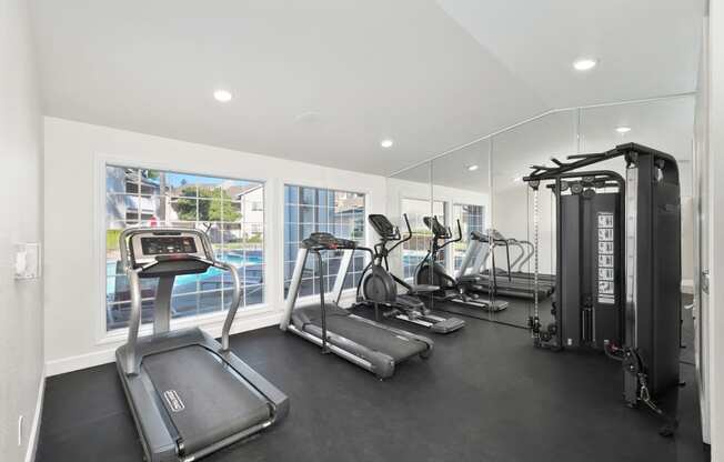 The on-site gym at The Legacy apartments is equipped with cardio machines and weights