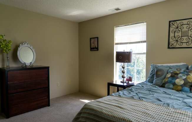 a bedroom with a bed and dresser