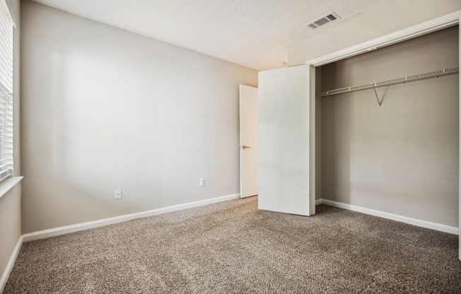 a bedroom with a closet and a window