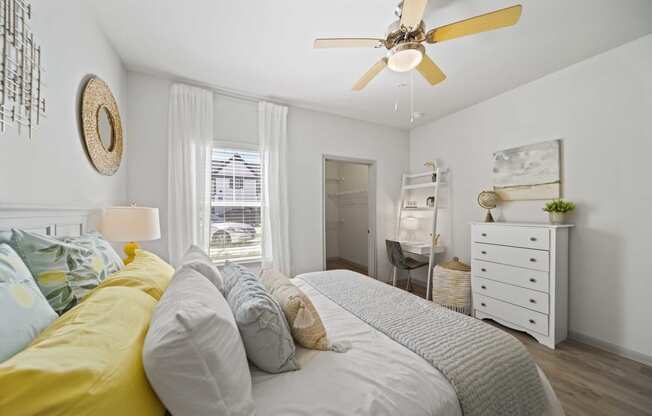 a bedroom with a bed and a ceiling fan