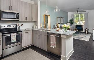 a kitchen with stainless steel appliances and a counter top at Promenade at Newnan Crossing, Newnan, GA