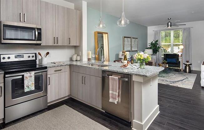 a kitchen with stainless steel appliances and a counter top at Promenade at Newnan Crossing, Newnan, GA