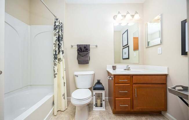 A bathroom with a white toilet, a white sink, and a white bathtub.