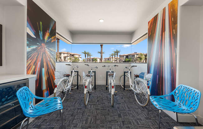 A room with a firework mural on the wall and bicycles parked in front of it.