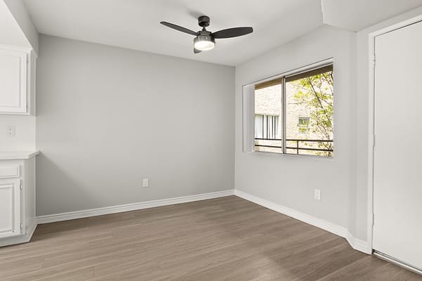 an empty living room with a ceiling fan and a window at NOHO GALLERY Apartments, California, 91601 