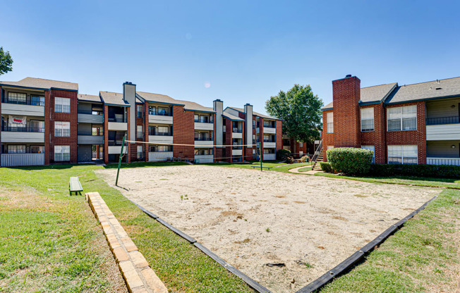 an empty yard in front of an apartment building