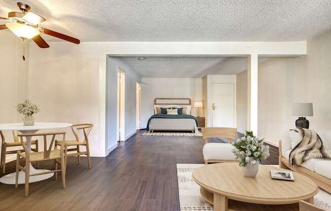 A living room with a dining table and chairs.