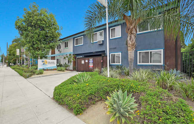 A blue building with a sign that says "BLOOM" in front of it.
