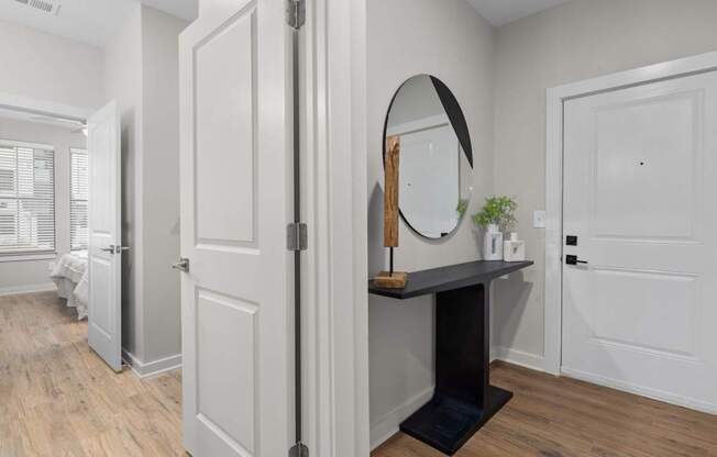 A white door with a mirror above it.at Century Grove Park, North Carolina