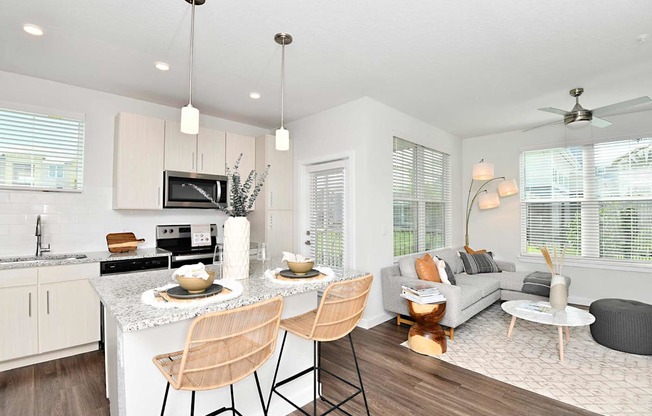 A modern kitchen with a dining table and chairs.