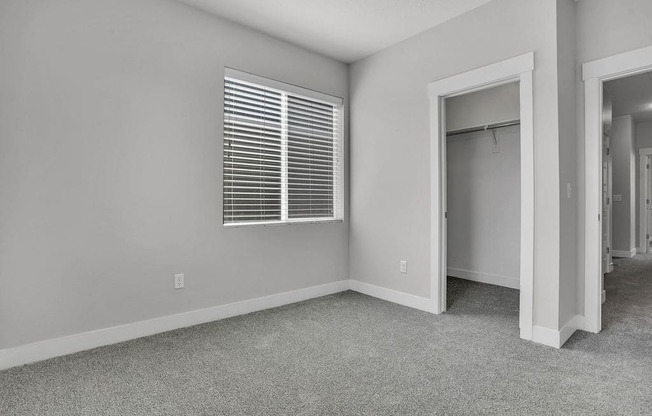 A room with a window and a door.