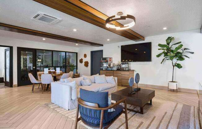 a living room filled with furniture and a large window at The Flats at Riverwoods, Provo, Utah