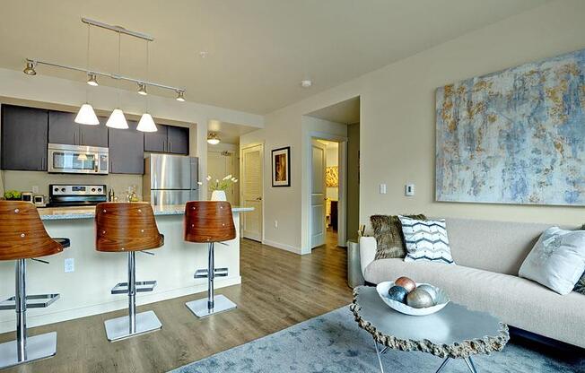 A modern kitchen with a bar stool and a countertop. at Kirkland Crossing Apartments, Kirkland, WA, 98033