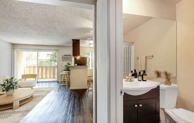 A bathroom with a white sink and a toilet.