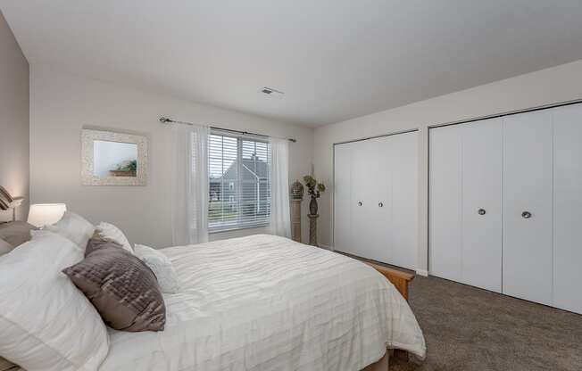 Bedroom with cozy bed and window at Normandy Club, Centerville, OH, 45459