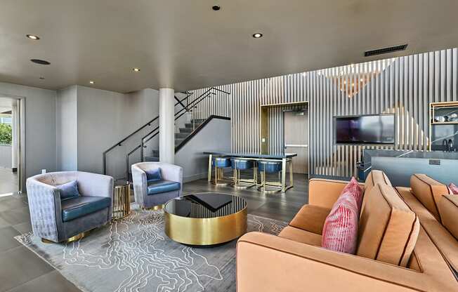 A living room with a staircase and a television.