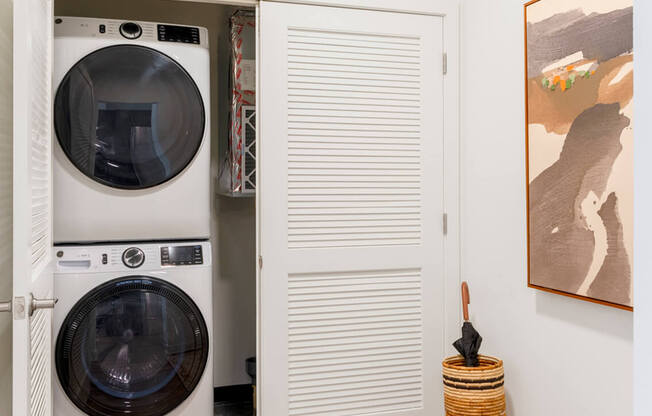 A washing machine is in a small laundry room.at The Vale at the Parks, Washington