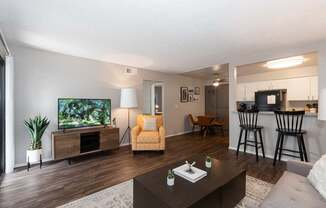 A living room with a television and a yellow chair.