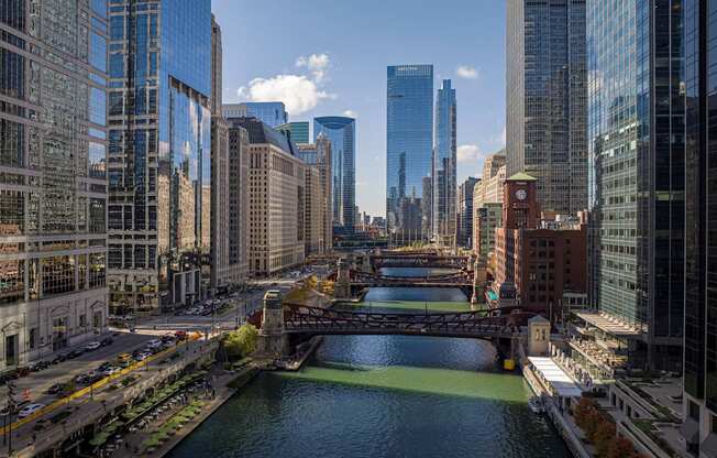 a view of the river with a bridge and skyscrapers