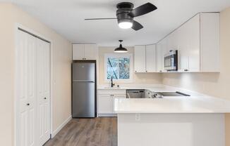 The Reserve at Bucklin Hill Apartments  kitchen with white cabinets and a stainless steel refrigerator