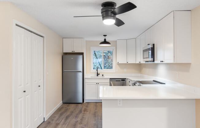 The Reserve at Bucklin Hill Apartments  kitchen with white cabinets and a stainless steel refrigerator