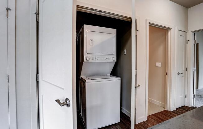 a small closet with a refrigerator and a washing machine in it at Woodcreek, Washington