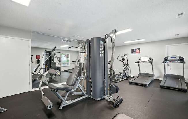 A gym with a variety of equipment including a leg press machine.