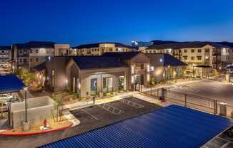 a building with a parking lot at night